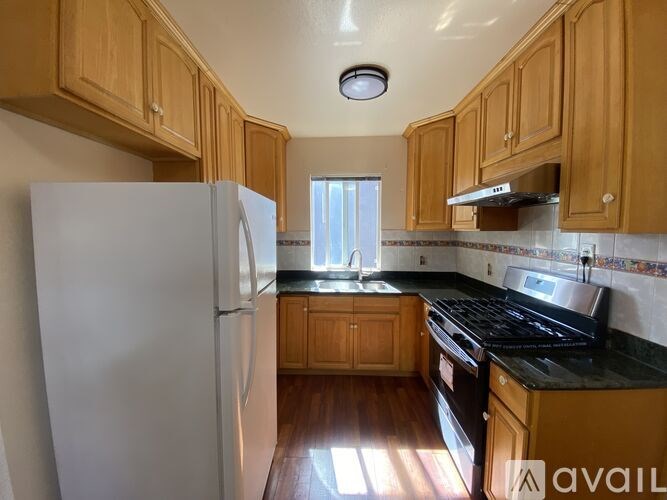 A kitchen with wooden cabinets and a white refrigerator.