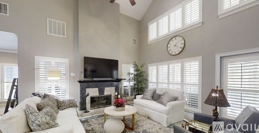 A living room with a fireplace and a television.