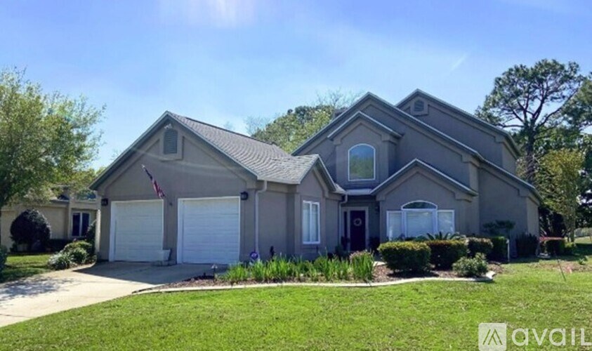 A house with a garage and a flag on the roof.