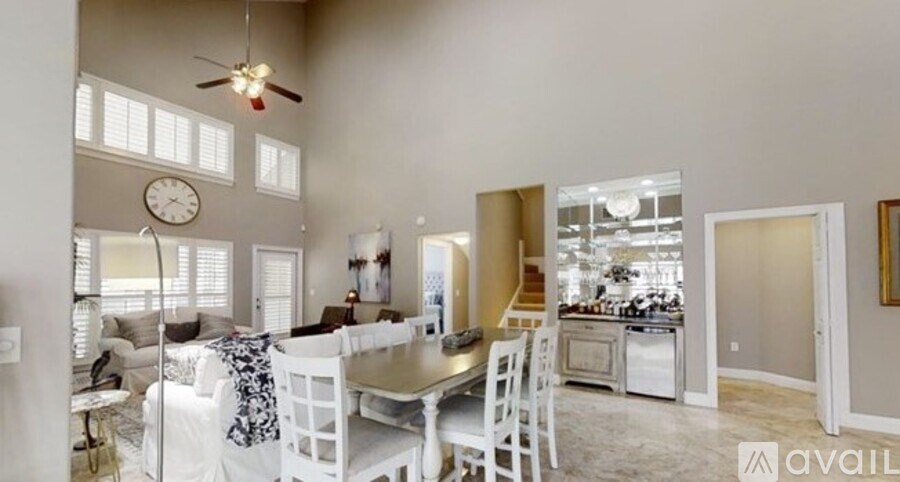 A spacious kitchen and dining area with a white color scheme.