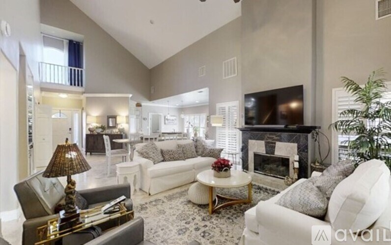 A living room with a fireplace and a television.