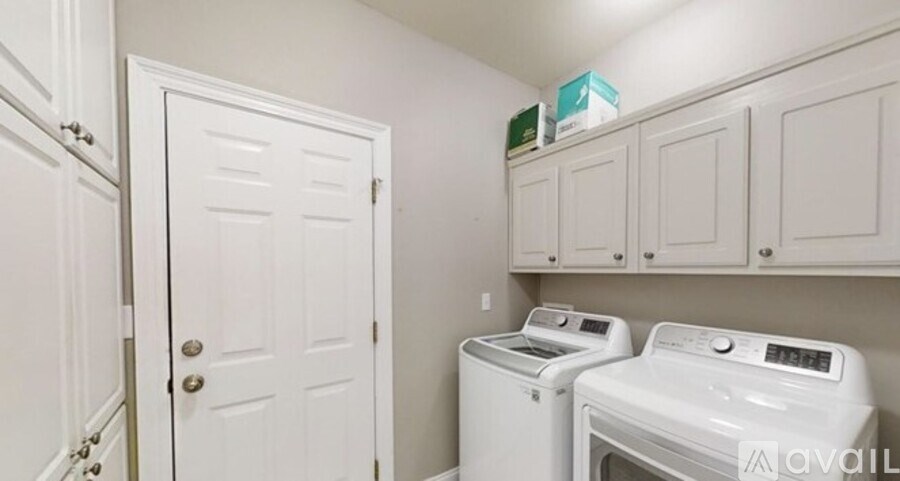 A small laundry room with a washer and dryer.