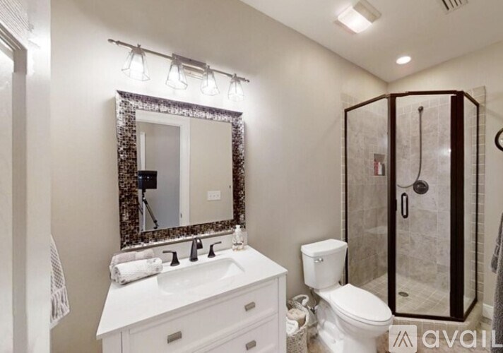 A bathroom with a white sink and a mirror above it.