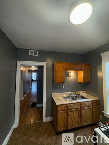 A kitchen with wooden cabinets and a sink.