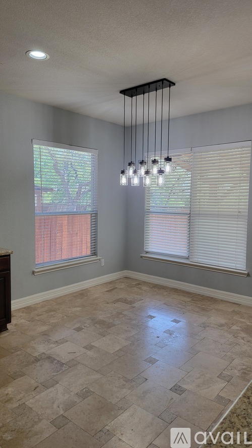 A room with a tiled floor and a chandelier.