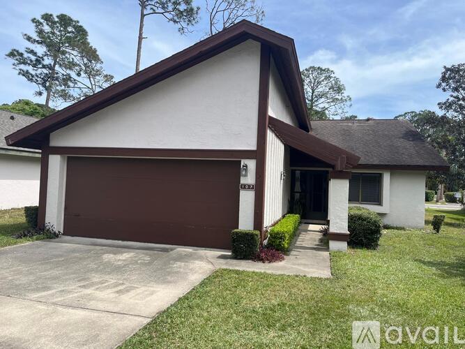 A house with a brown garage door is for sale.