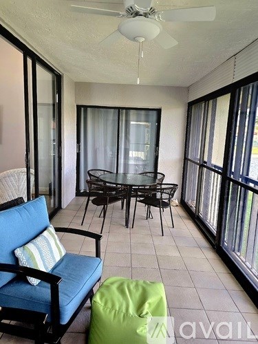 A balcony with a table and chairs.