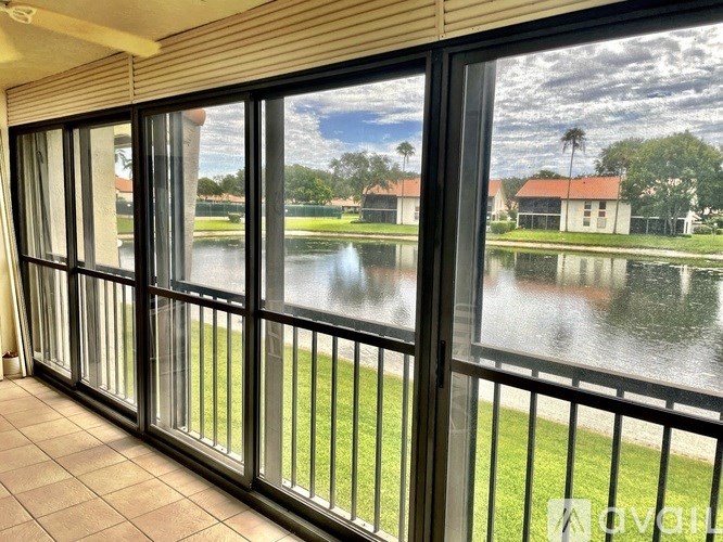 A view from a balcony looking out at a body of water and houses.
