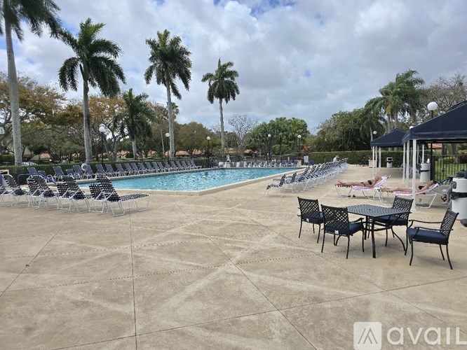 A pool area with chairs and tables is available for use.