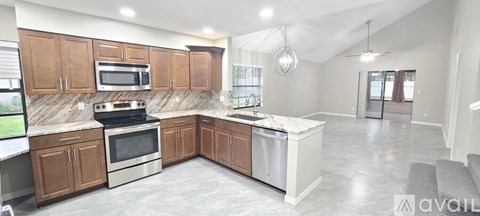 A kitchen with brown cabinets and a white island.