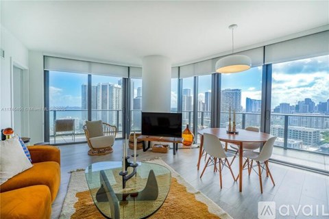A modern living room with a glass table and orange chairs.