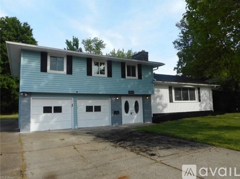 A blue and white two-story house with a garage.
