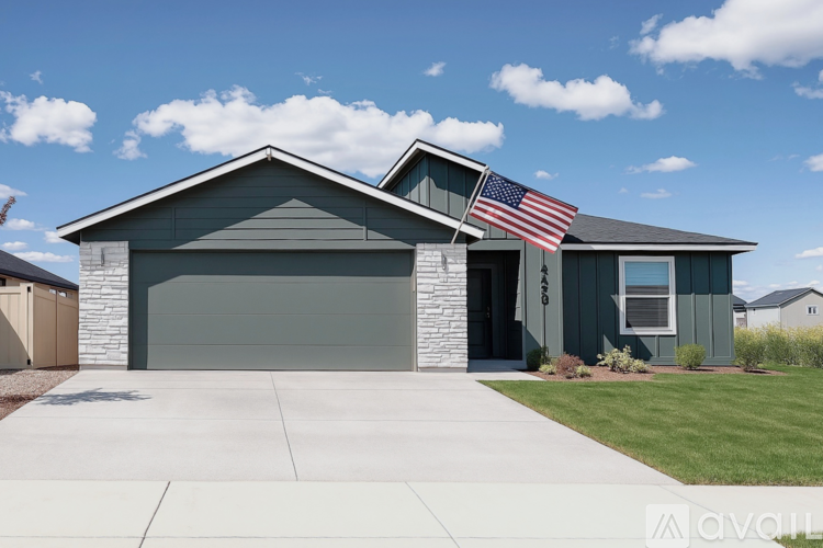 A house with a garage and an American flag hanging on the wall.