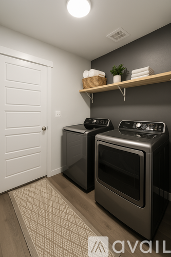 A kitchen with a black oven and a white door.