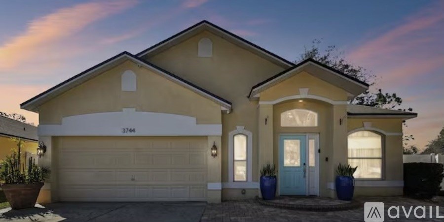A house with a blue door and a garage.