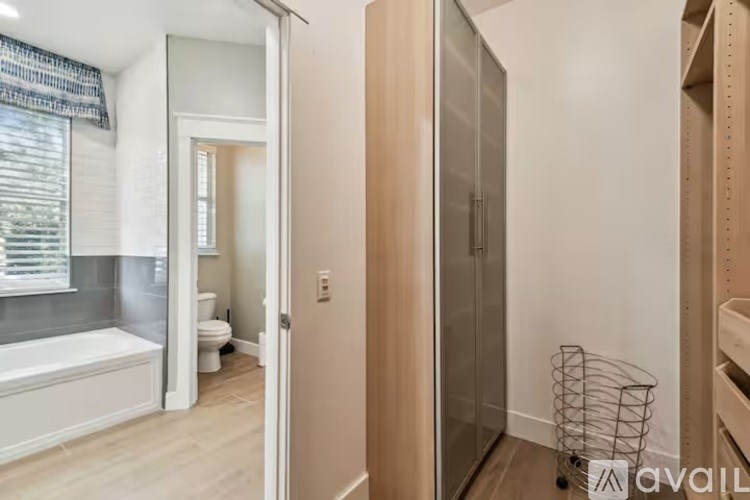 A bathroom with a tub, toilet, and a walk-in shower.