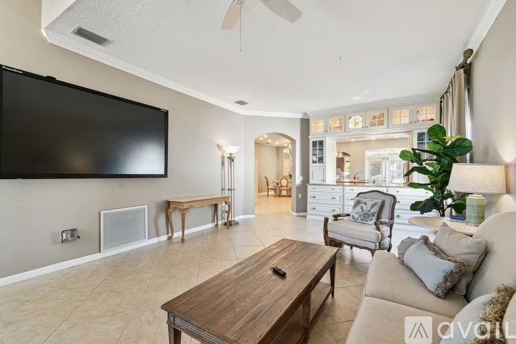 A living room with a television, a couch, and a coffee table.