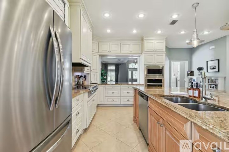 A modern kitchen with a stainless steel refrigerator and wooden cabinets.