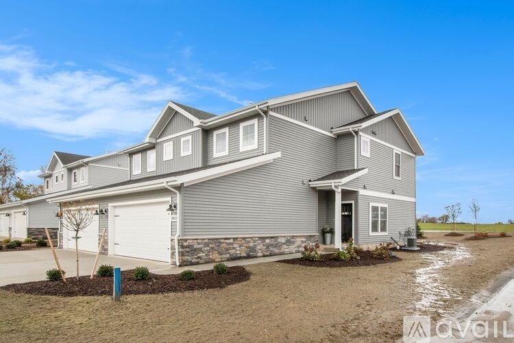 A large, two-story house with a garage is available for purchase.