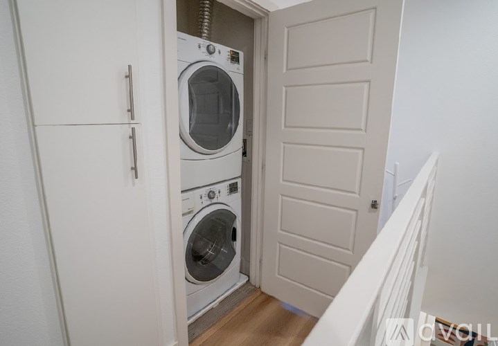 A white washing machine and dryer in a small laundry room.