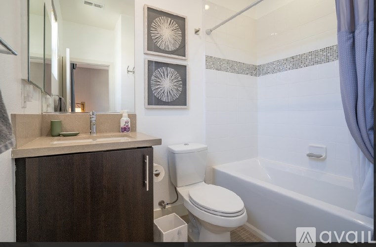 A bathroom with a toilet, sink, and bathtub.