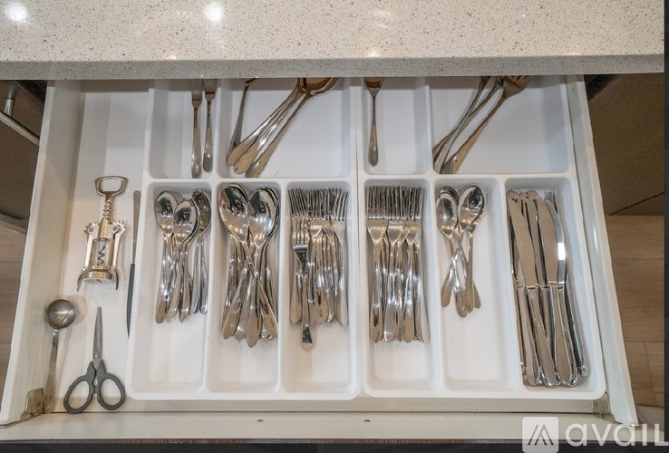 A drawer full of silverware including forks, knives, and spoons.