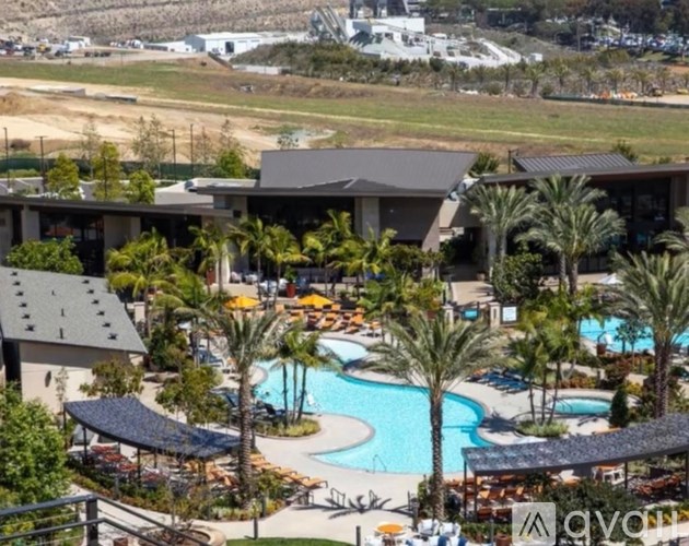 A resort with a pool and palm trees.