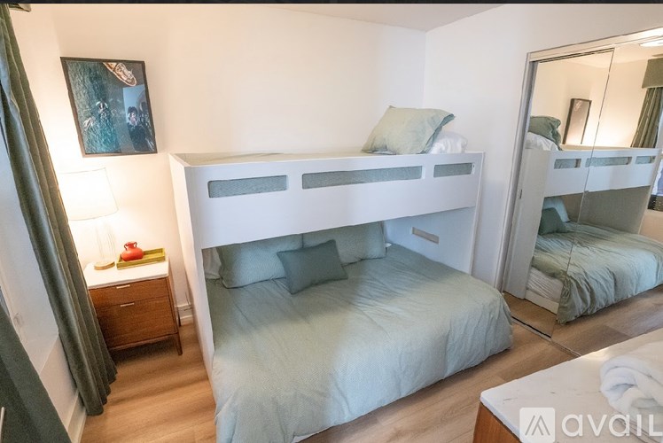 A bedroom with a bunk bed and a single bed.