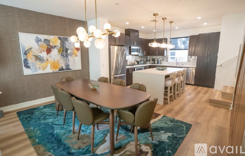 A modern dining room with a large table and chairs.