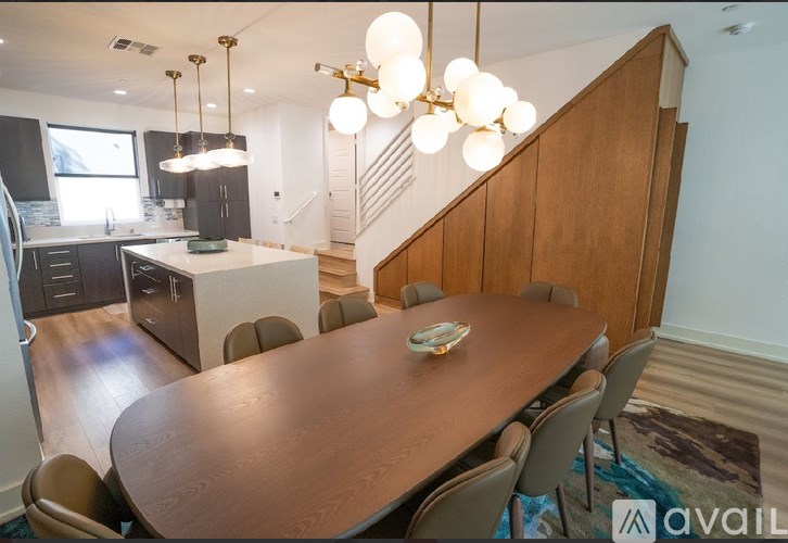 A dining room with a wooden table and chairs.