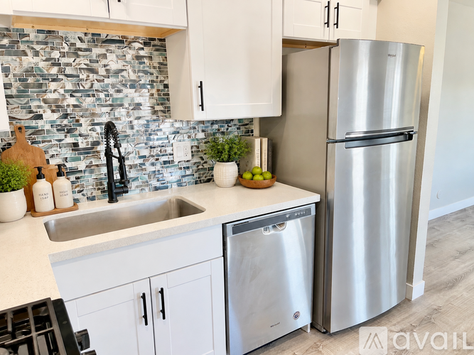 A kitchen with a sink and a dishwasher.