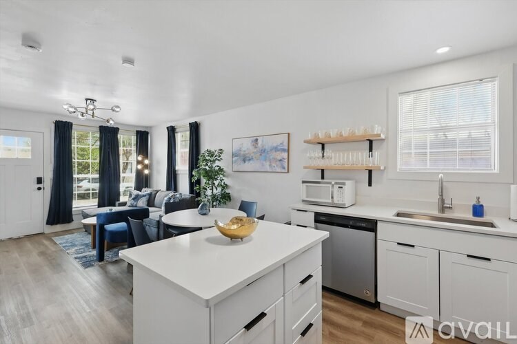 A modern kitchen with white cabinets and a large island.