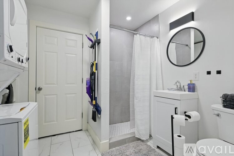A bathroom with a white toilet, sink, and a white shower curtain.