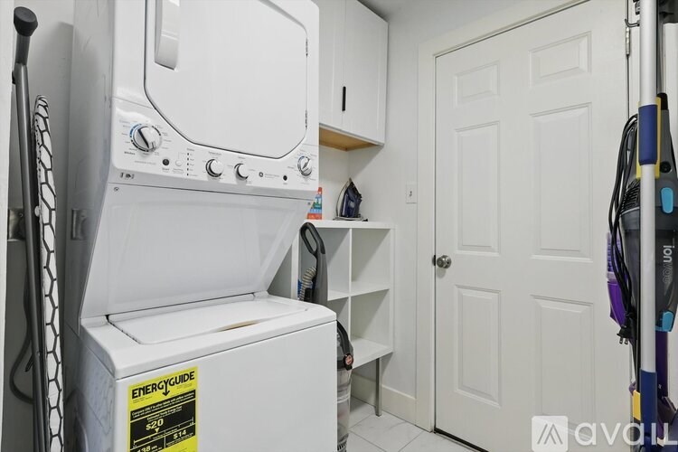 A white EnergyGuide label is on a white dryer.