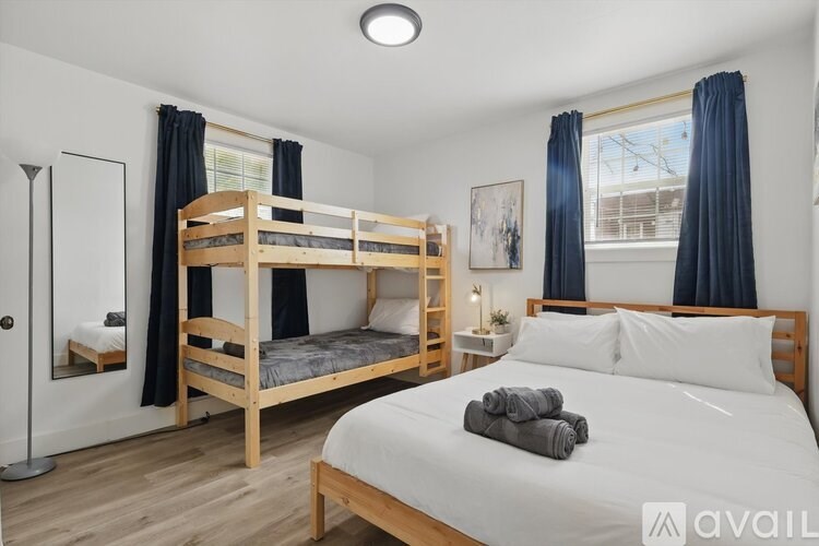 A bedroom with a large bed and a bunk bed.