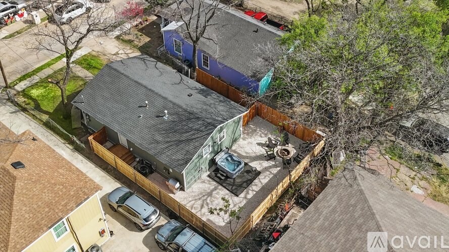 A bird's eye view of a house with a garage and a car parked in front.