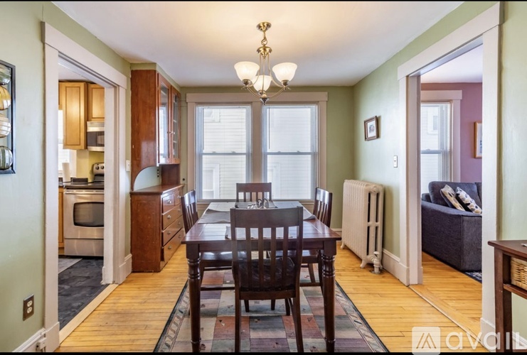 A dining room with a table and chairs.