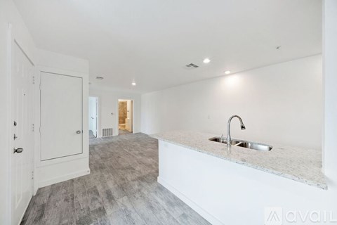 A kitchen with a sink and a counter top.