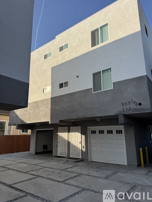 A modern building with a flat roof and a garage door.