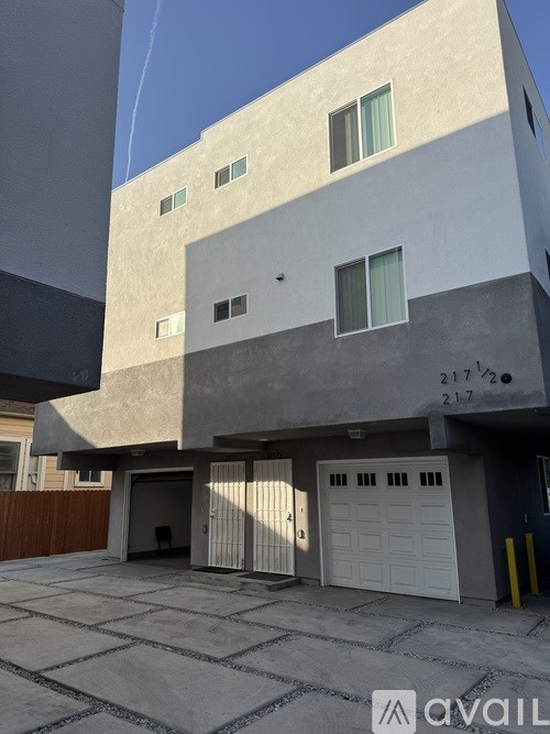 A modern building with a flat roof and a garage door.
