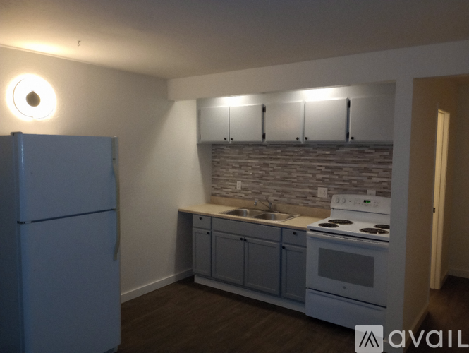A kitchen with a white stove and blue fridge.