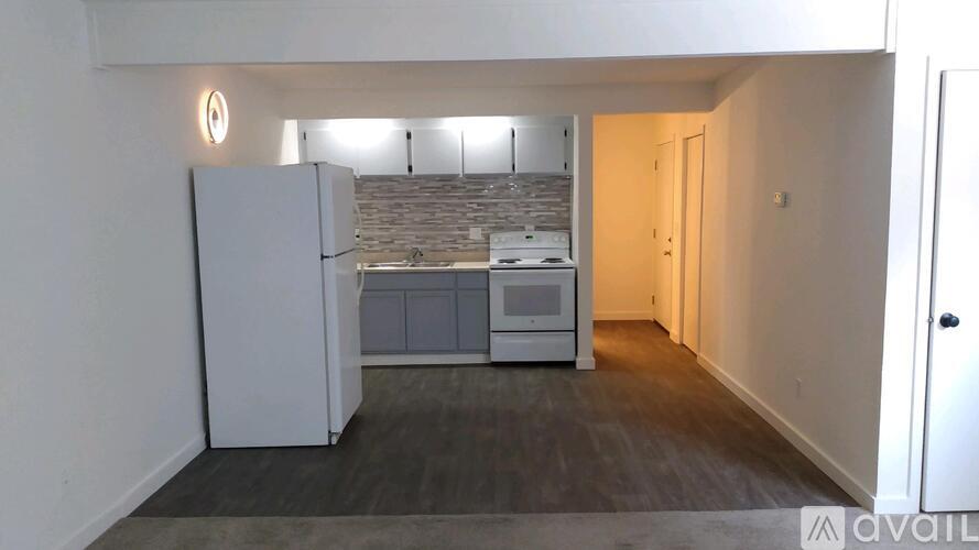 A kitchen with a refrigerator, microwave, and oven.