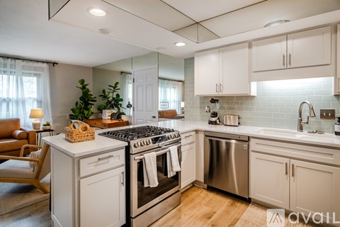 A modern kitchen with a stove top oven and a dishwasher.