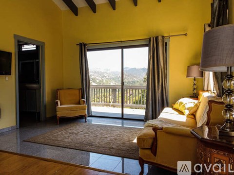 A bedroom with a large bed and a view of the city.