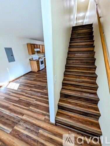 A wooden staircase leads up to a second floor.