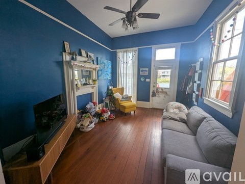 A living room with a grey couch and a television.