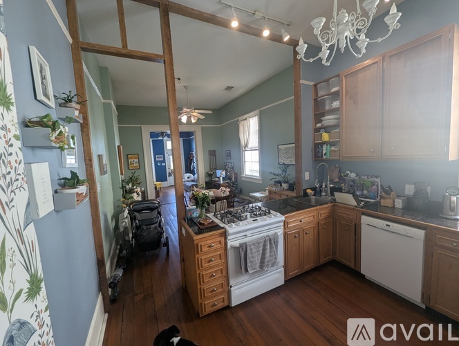 A kitchen with wooden cabinets and a white dishwasher.
