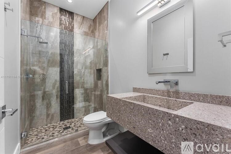 A bathroom with a marble toilet and sink.