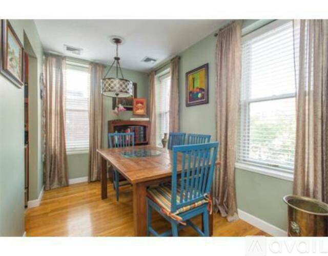 A blue chair sits in front of a wooden table.