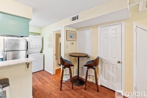 A kitchen with a table and chairs in the middle of the room.